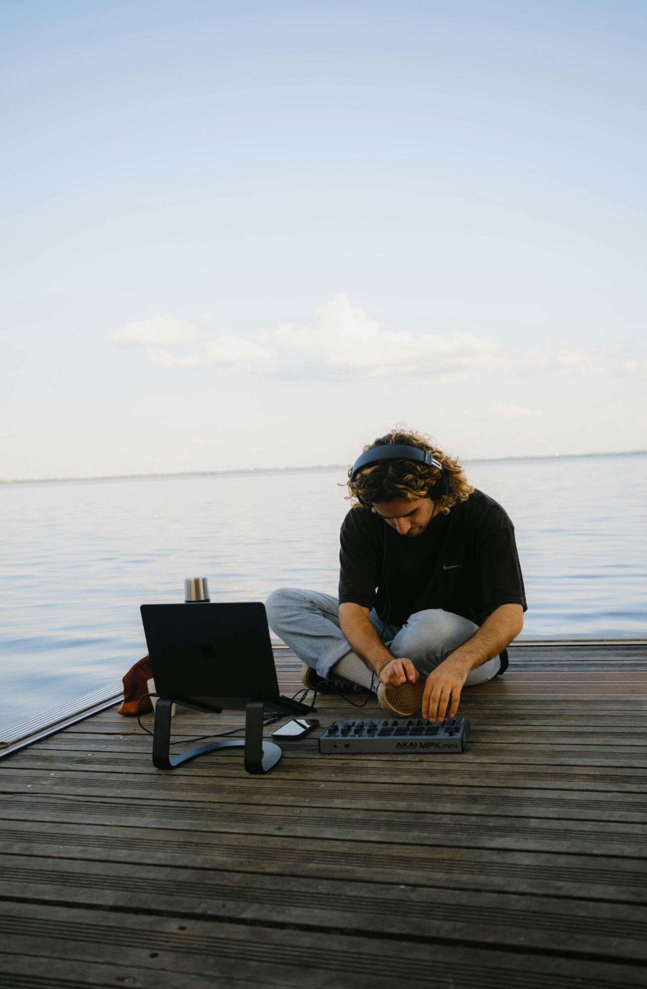 Freelancer working on a laptop on a terrace with lake background