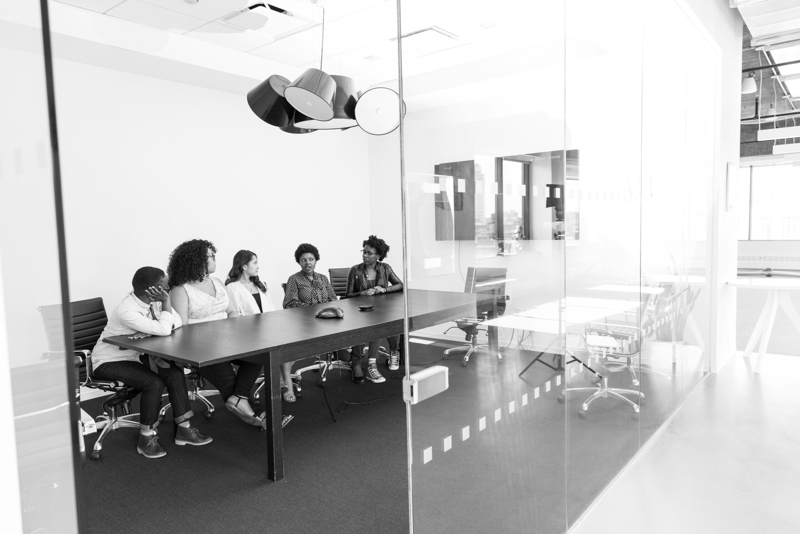 High quality photo of young professionals brainstorming in a casual, well-lit coworking lounge area