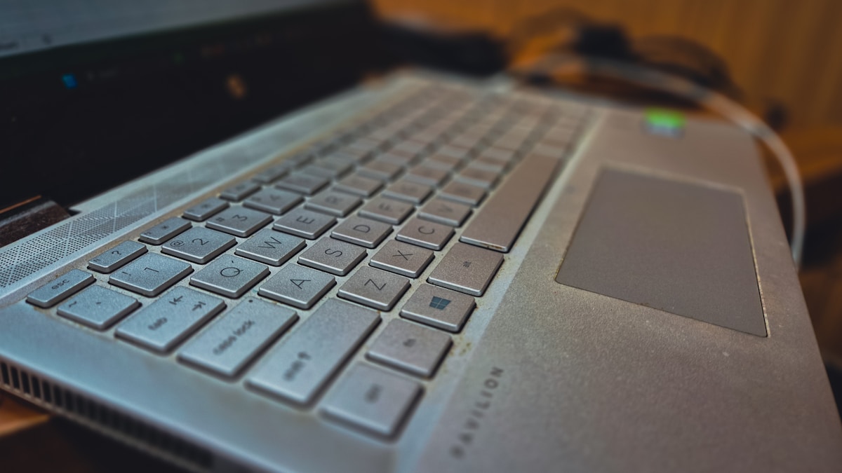 A laptop computer sitting on top of a wooden desk